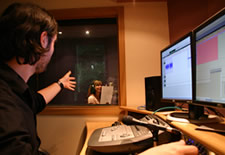 Studio control with sound engineer directing a voice talent at PrimeVoices’ studio 2
